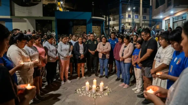 Imagen de vigilia nocturna en Coishco con velas encendidas en honor a las tres víctimas de sicariato de una misma familia. Vecinos de la zona de Chimbote muestran respeto y dolor.